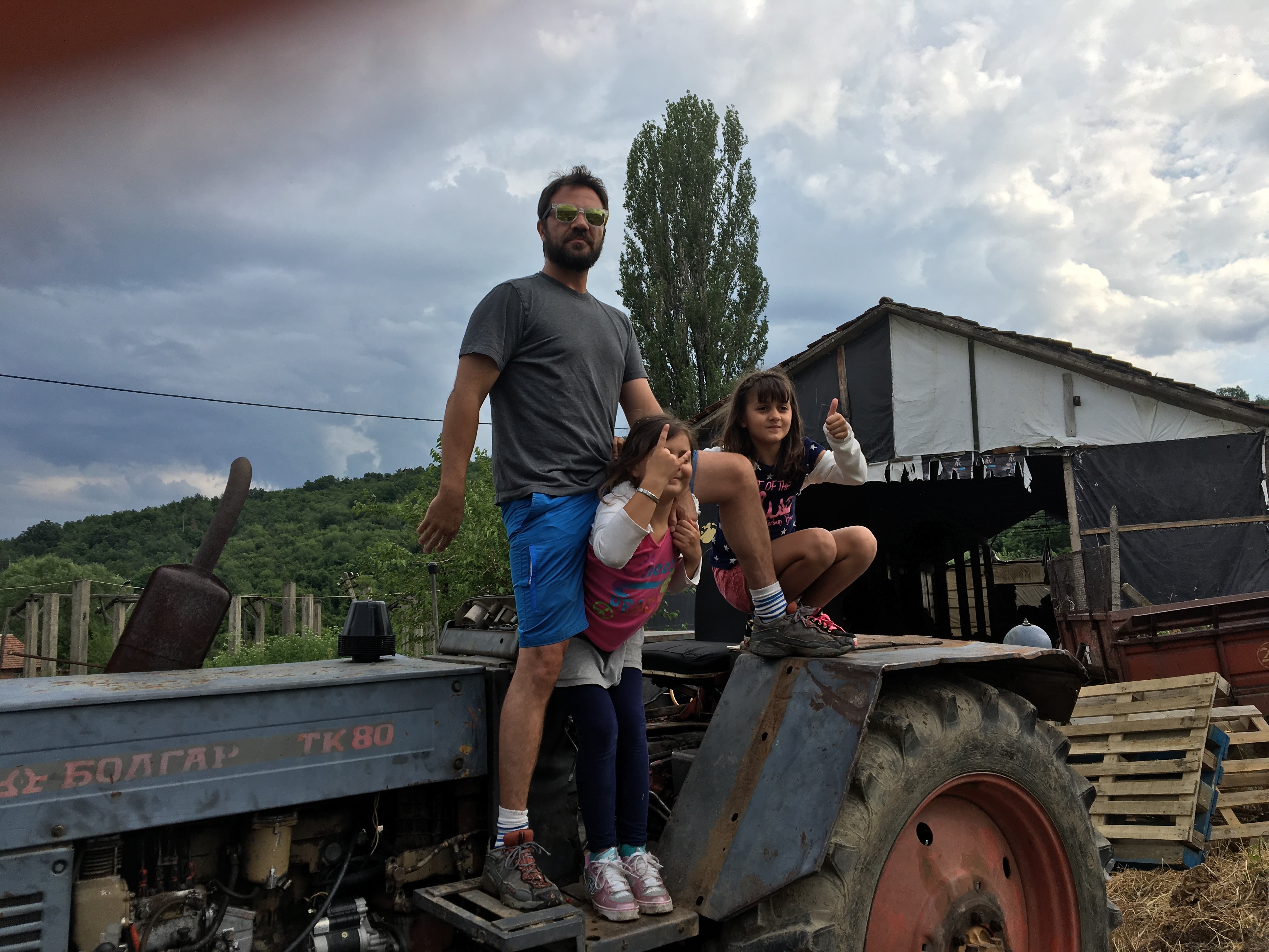 Dad and daughters on an old tractor